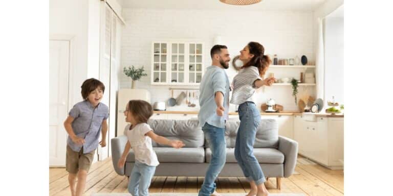 An image of a family dancing in their small room that feels bigger