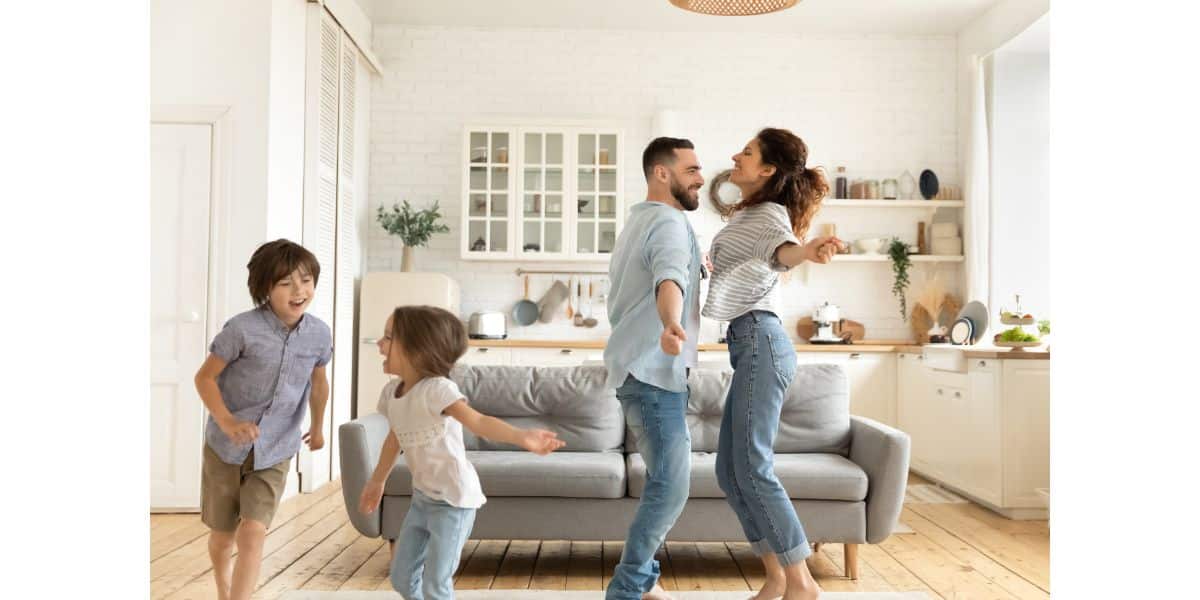 An image of a family dancing in their small room that feels bigger