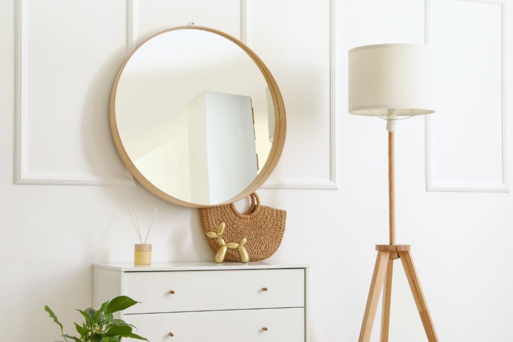 A mirror hunged on the wall to save safe in the living room and make it feel bigger