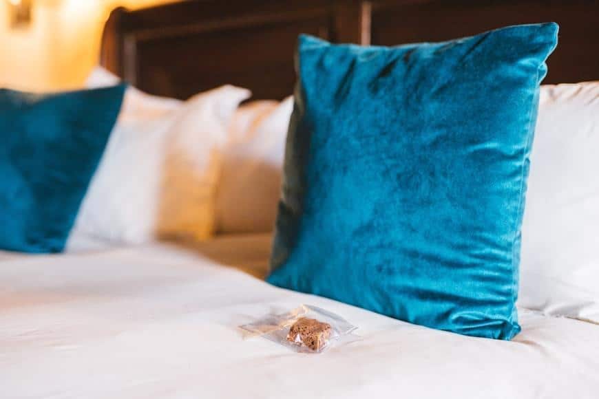 Decorative pillow laying on top of the bed