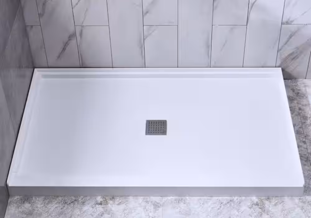 A solid surface shower pan base with center drain