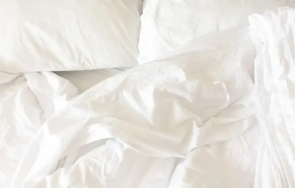 A clear image of bamboo sheets rumpled on a bed