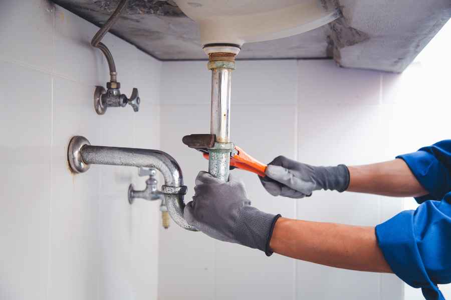 Professional plumber fixing a bathroom sewer sink from smelling like a sewer gas