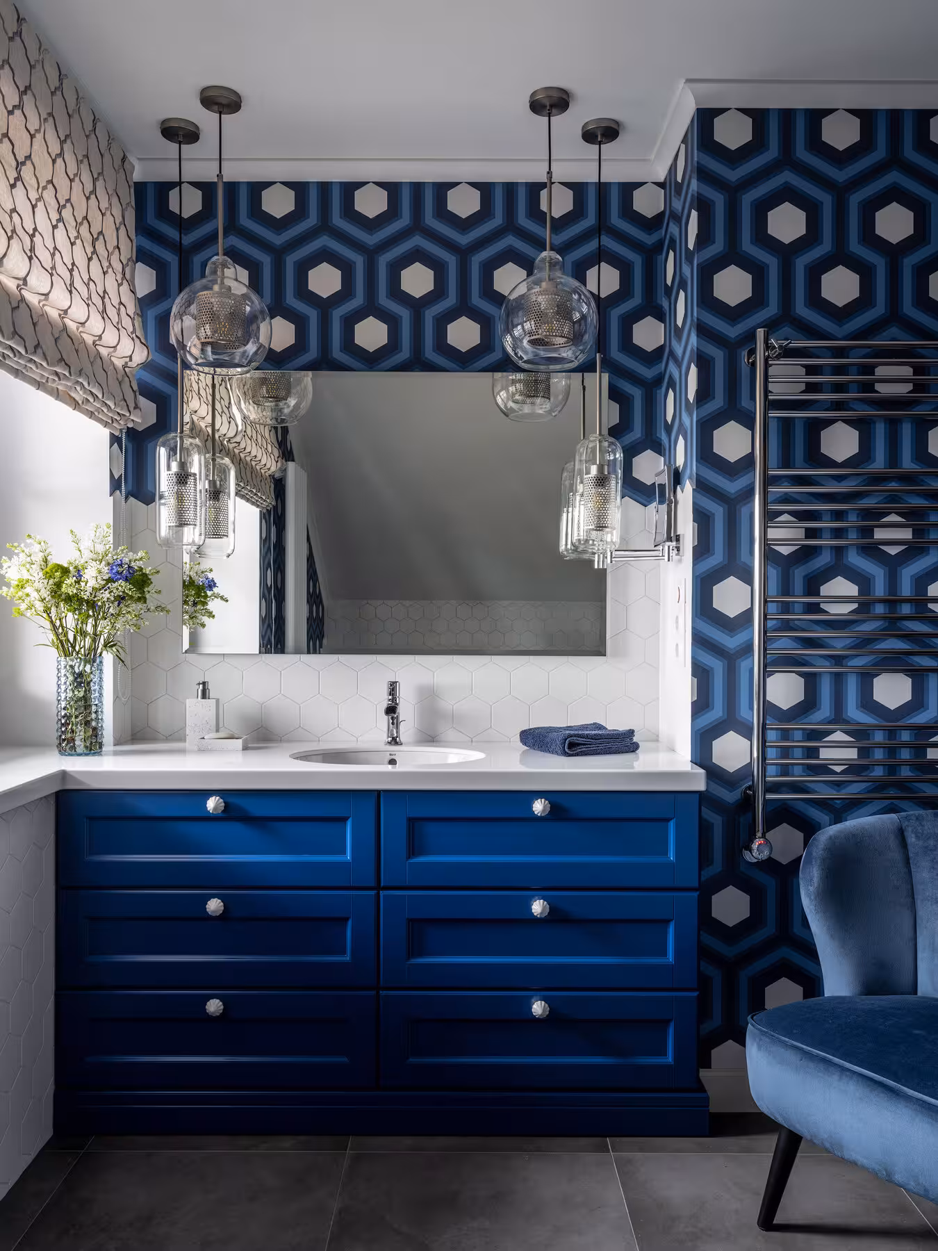 Blue bathroom vanity paired with geometric wallpaper