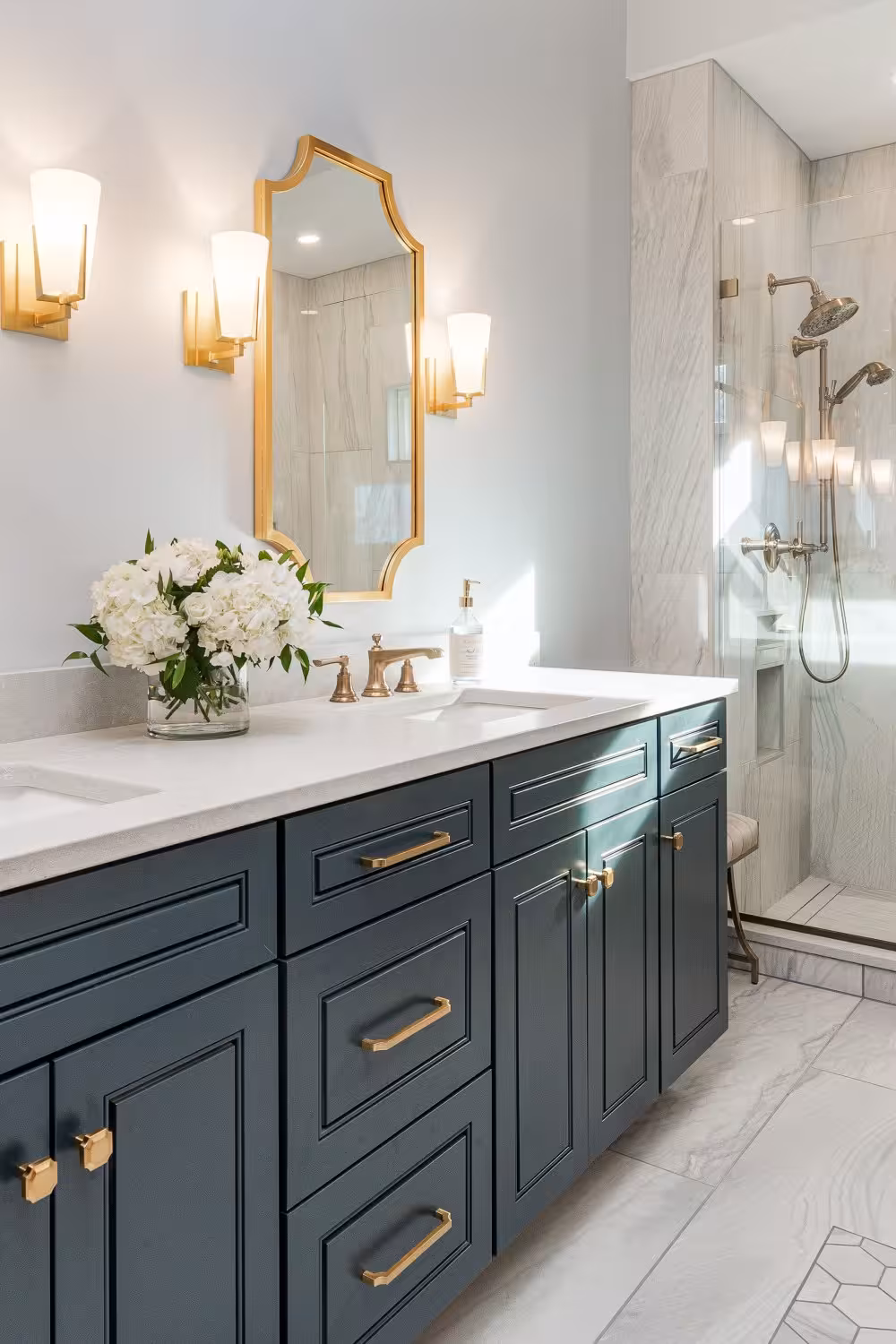 Duck blue bathroom cabinet with a gray porclain floor tiles and white contertop.