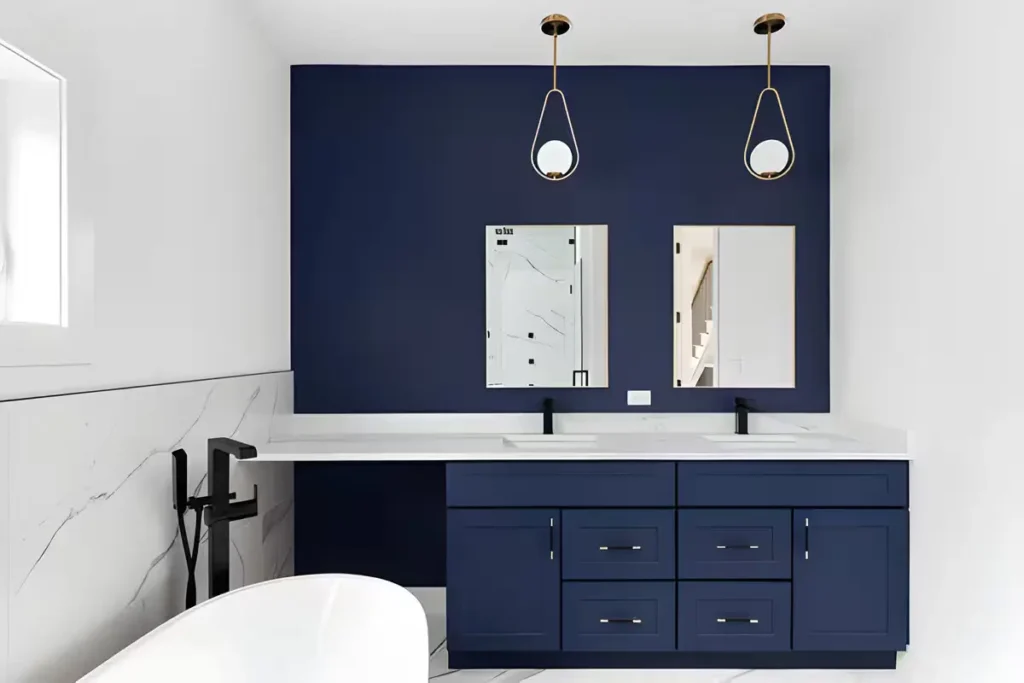 Blue vanity bathroom ideas in a white bathroom walls featuring a freestanding tub and two lights in the ceiling.