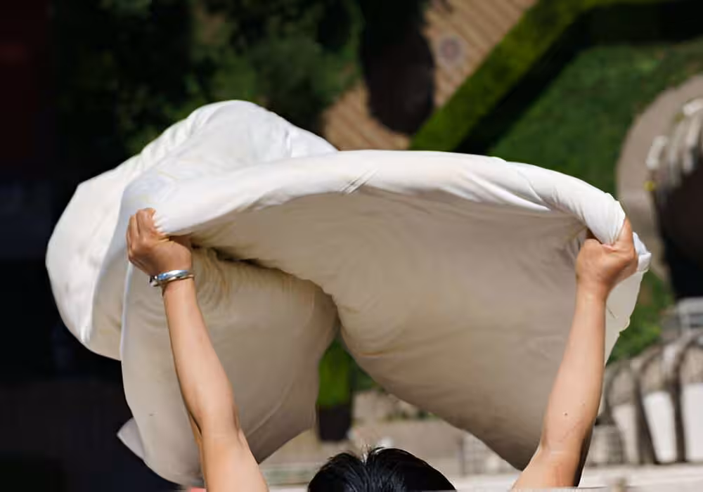 Woman drying a duvet cover cover outside