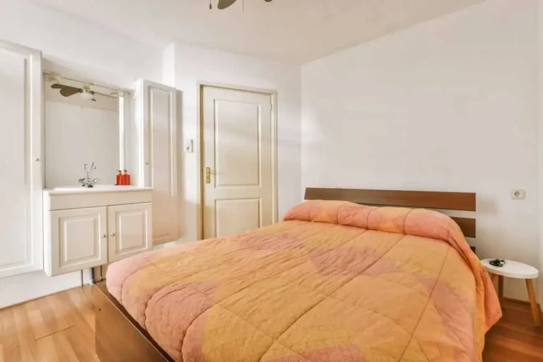 Orange king comforter on a queen bed