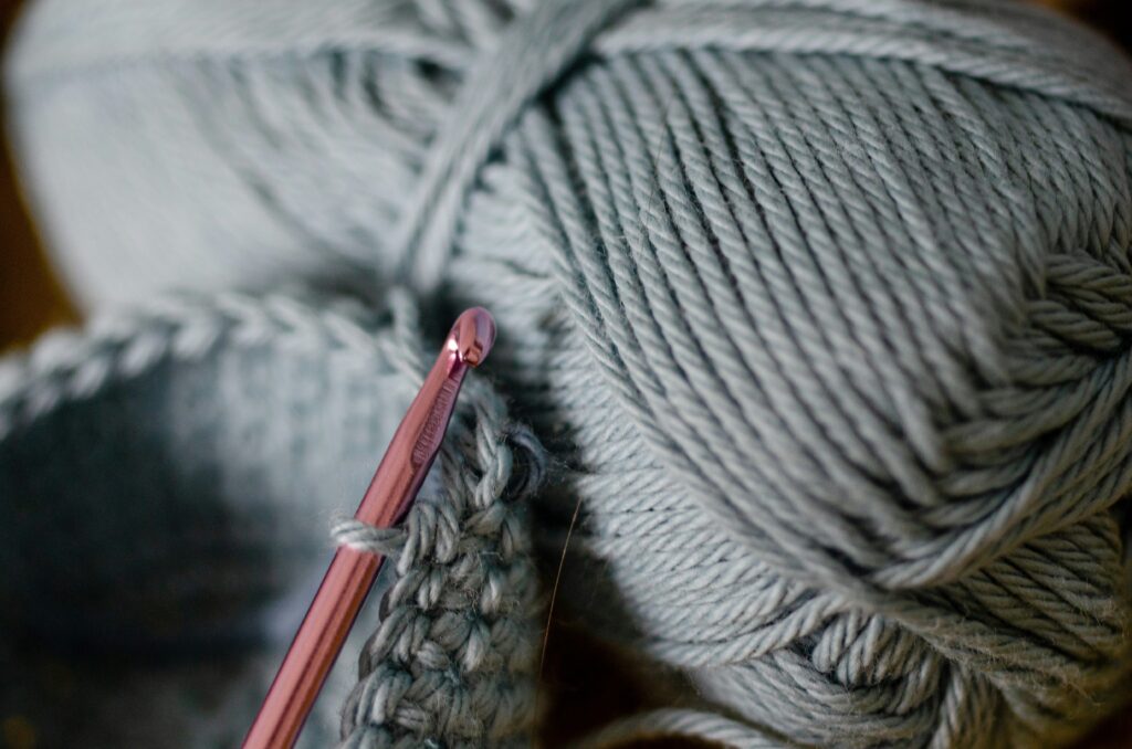 Mending holes and tears in a wool blanket for proper care and maintenance